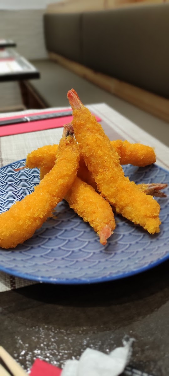 Breaded fried shrimp tempura on blue wave-patterned plate